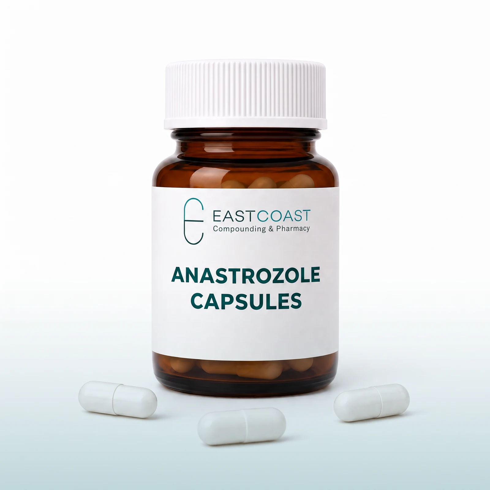 Anastrozole capsules in an amber pharmacy vial with East Coast Compounding & Pharmacy label, loose capsules beside it (illustrative image)