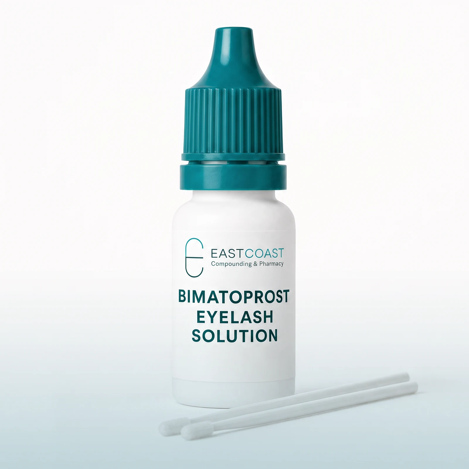 Bimatoprost eyelash solution in a white dropper bottle with teal cap, applicator brushes, East Coast Compounding & Pharmacy label (illustrative image)