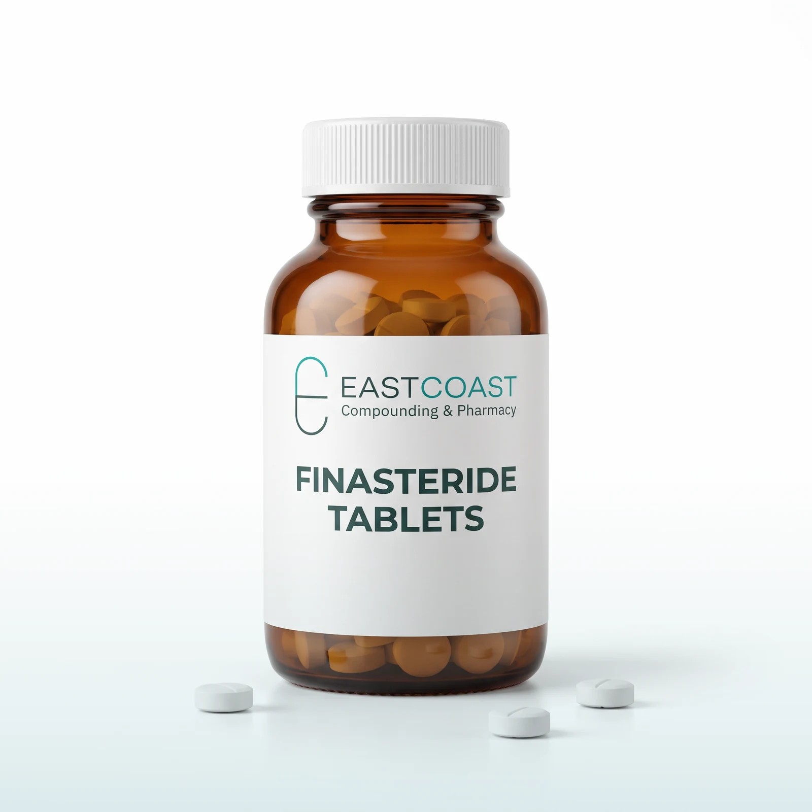Finasteride tablets in an amber pharmacy vial with East Coast Compounding & Pharmacy label, tan tablets beside it (illustrative image)