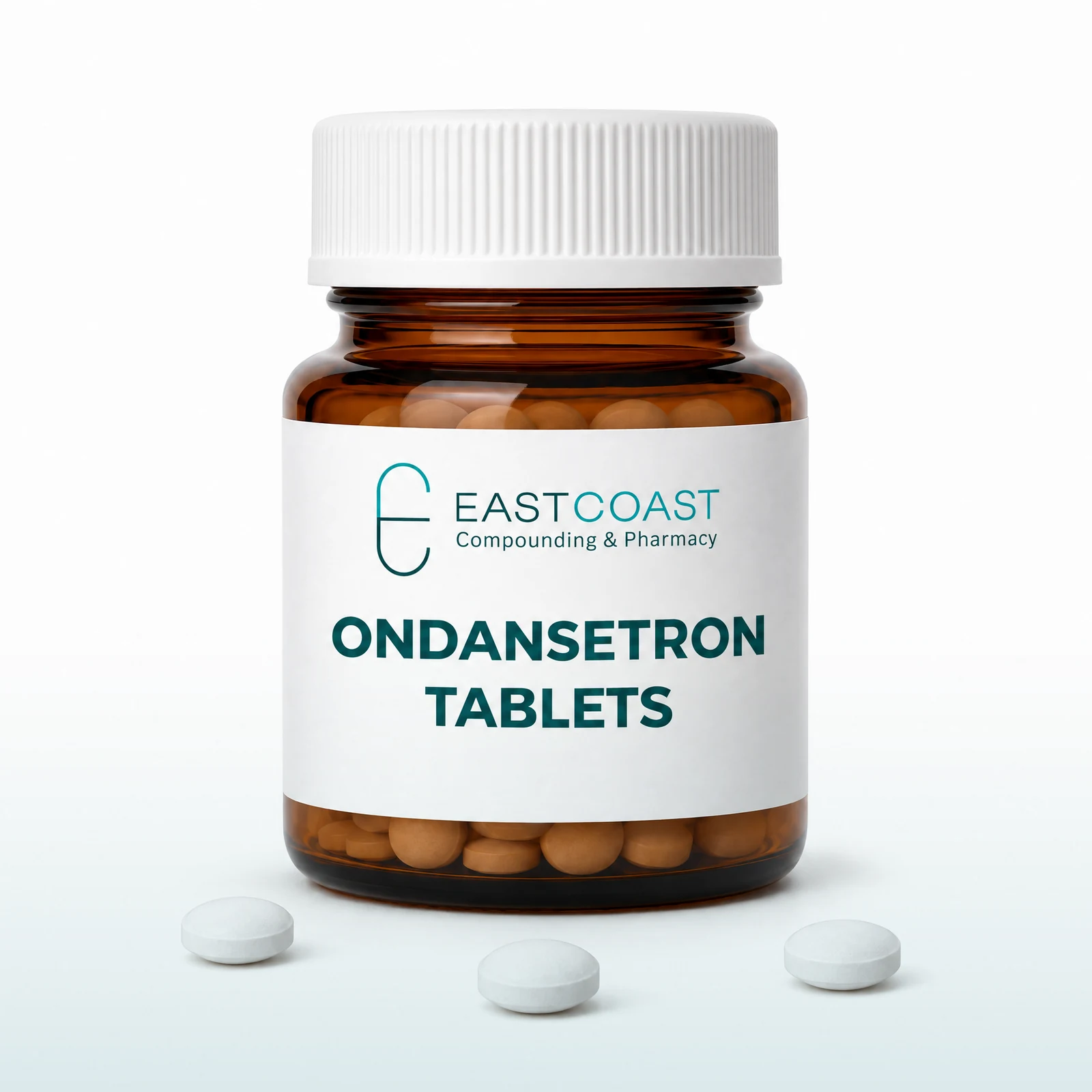 Ondansetron tablets in an amber pharmacy vial with East Coast Compounding & Pharmacy label, white tablets beside it (illustrative image)